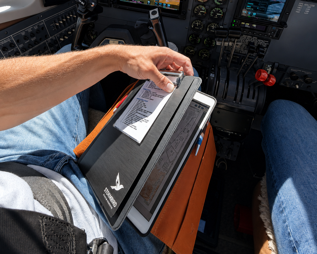 Pilot opening Stormbird premium heritage leather knee board to show clipboard and tablet organization in cockpit